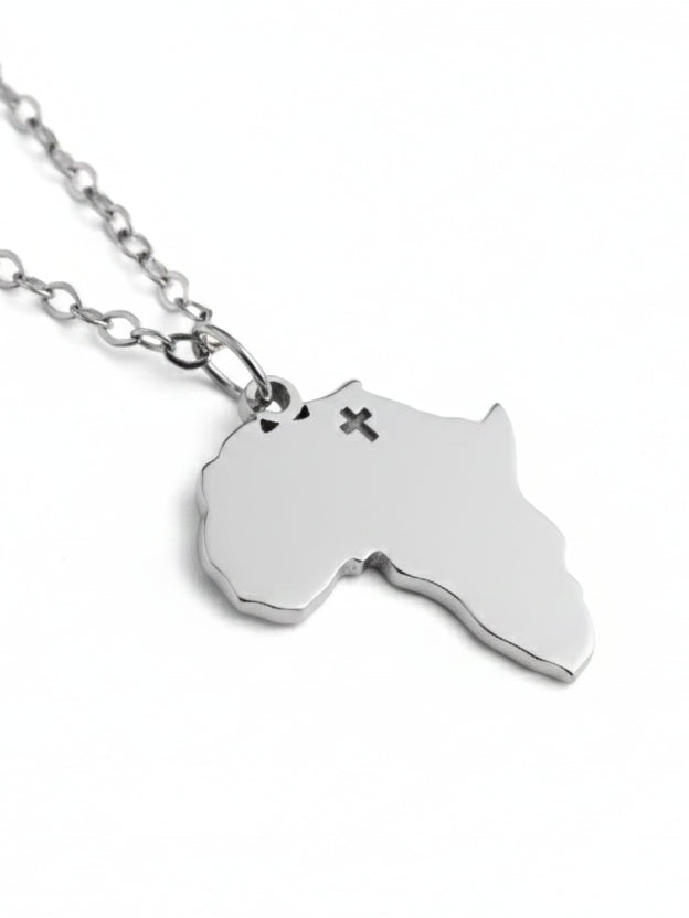 Silver necklace with a pendant shaped like the continent of Africa on a white background