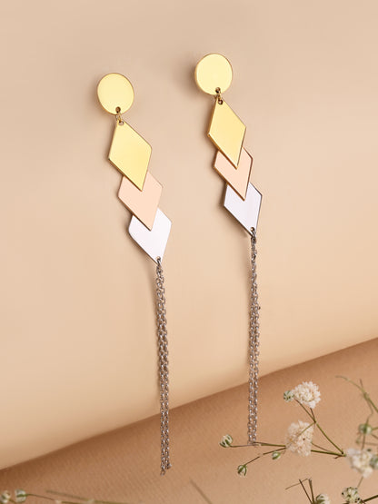 Gold and beige geometric earrings with chain details on a beige background
